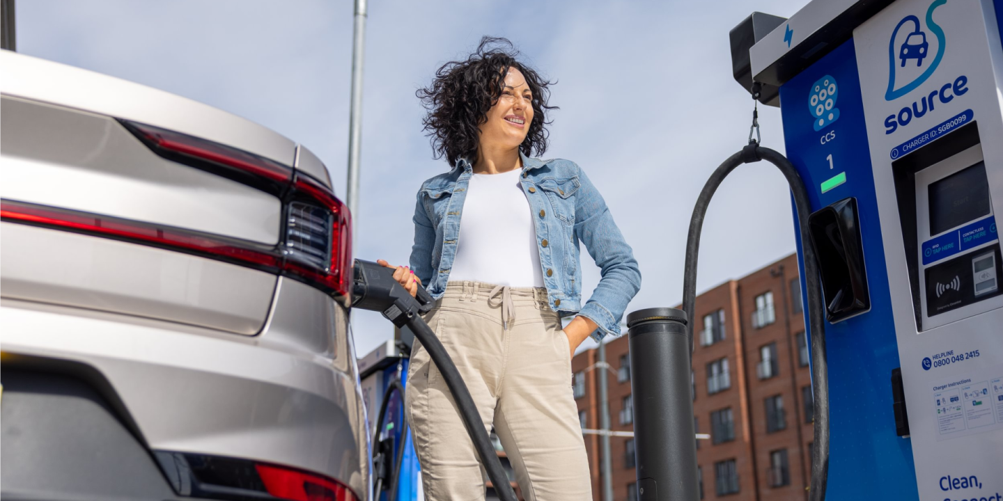 A woman charging at a source charger as part of the GreenFlux roaming network